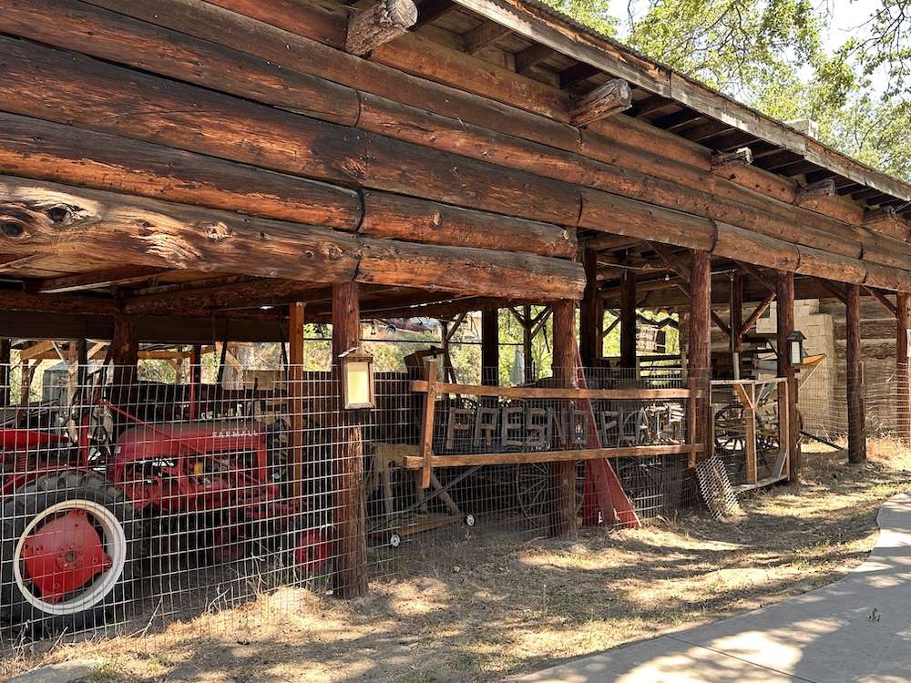 Stable with various vintage wagons and farm equipment