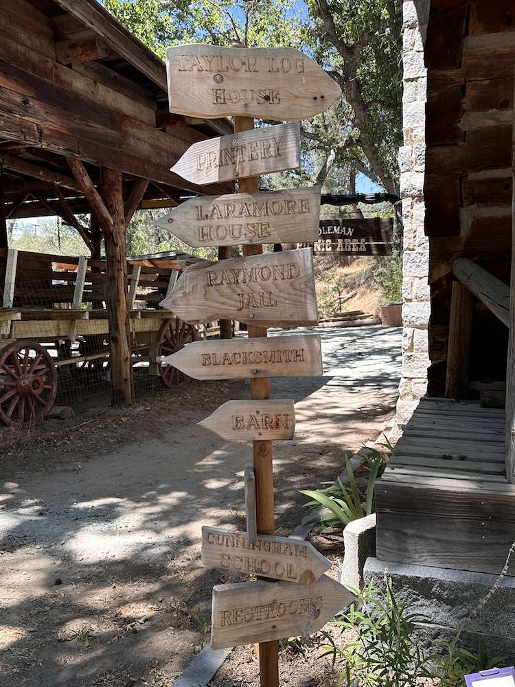 Hand lettered signs directing visitors to different spots around Fresno Flats