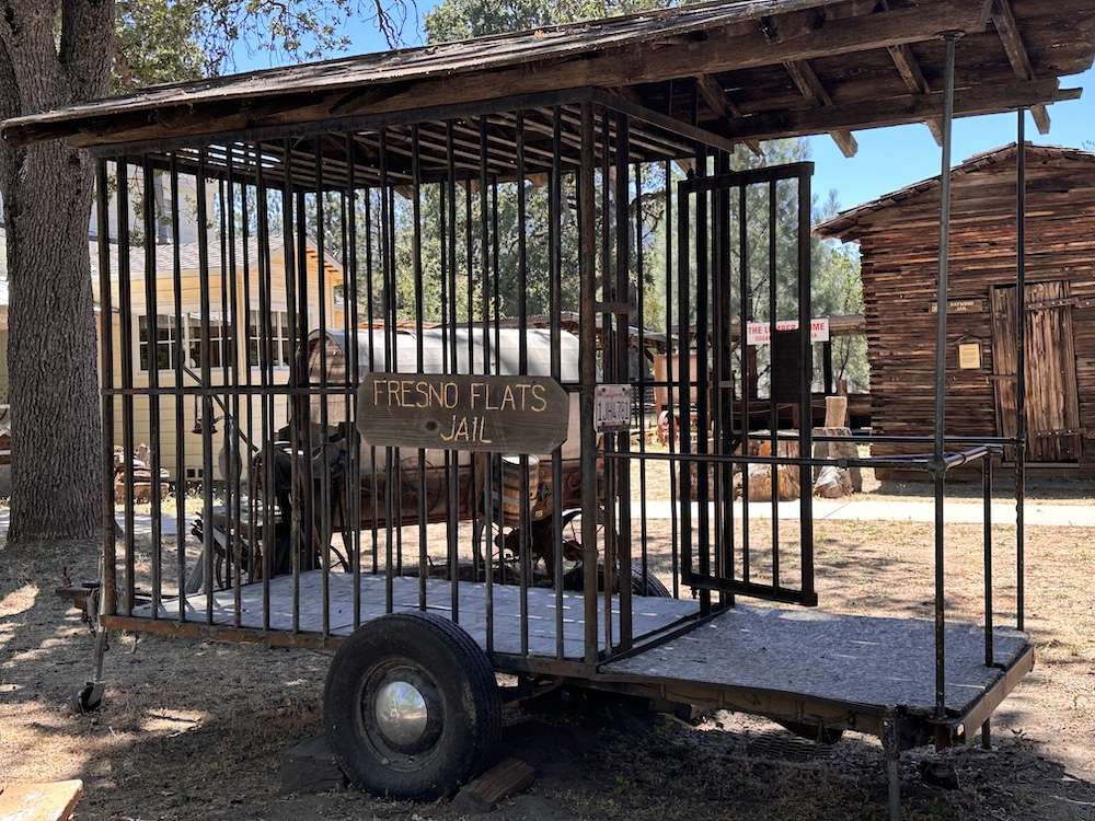 Vintage Mobile Jail with sign "Fresno Flats Jail" on wheels